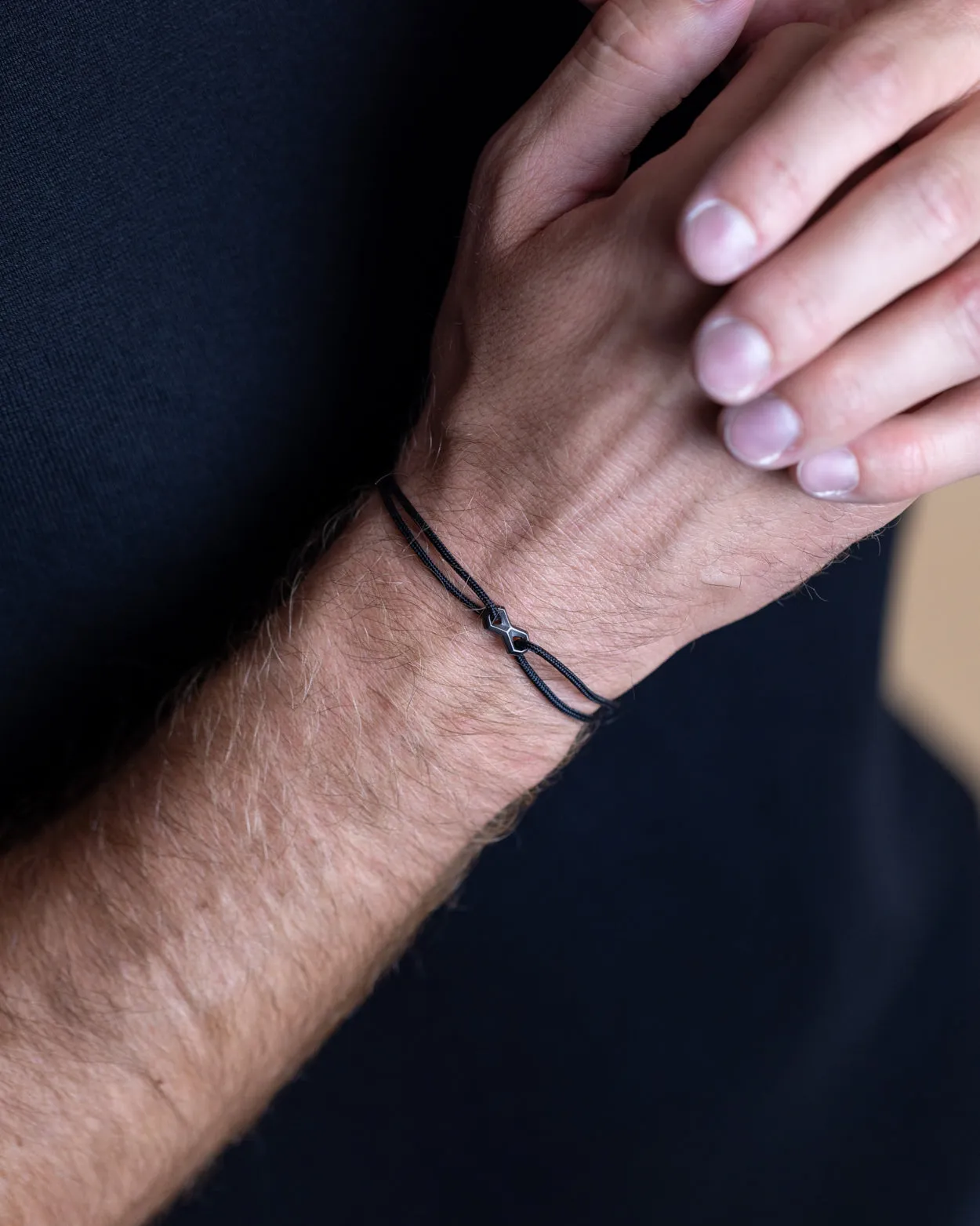 1.5mm Black nylon bracelet with a black Infinity sign